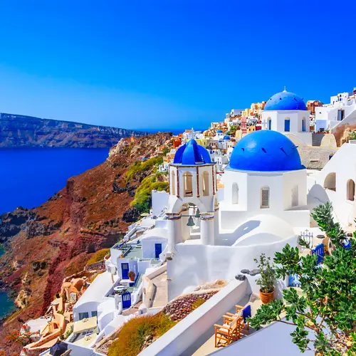 Scenic view of a European coastal town with waterfront and architecture.